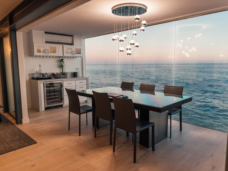 Dining area with a large window overlooking the sea